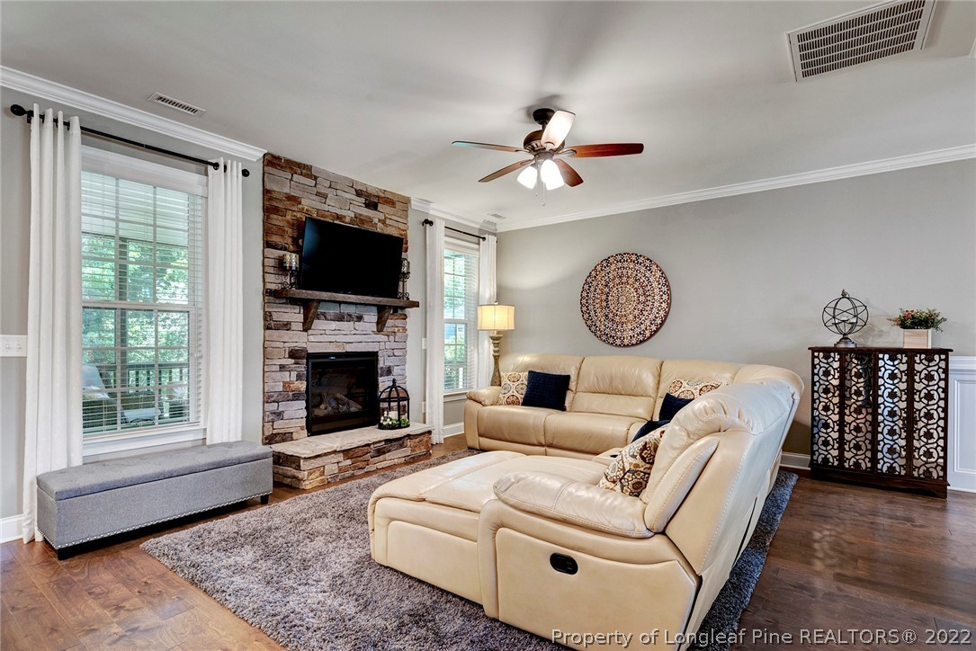 4139 Olde Judd Drive Willow Spring, NC 27592 - Photo 9 of 42 a living room with furniture a fireplace and a flat screen tv