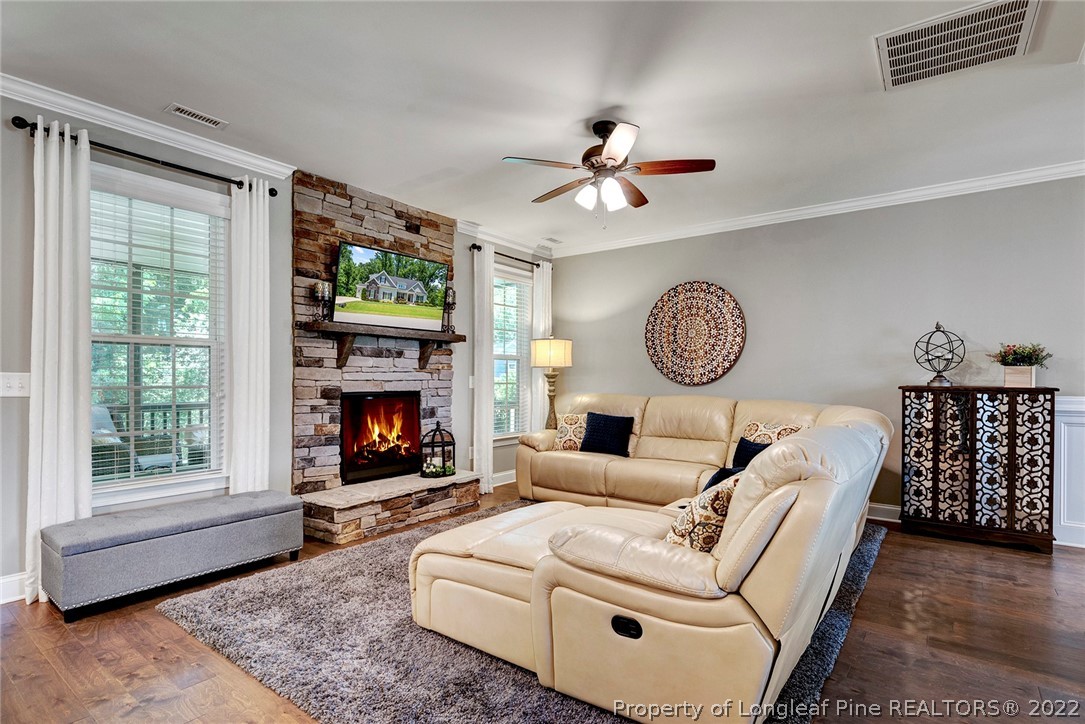 4139 Olde Judd Drive Willow Spring, NC 27592 - Photo 10 of 42 a living room with furniture a fireplace with a large window