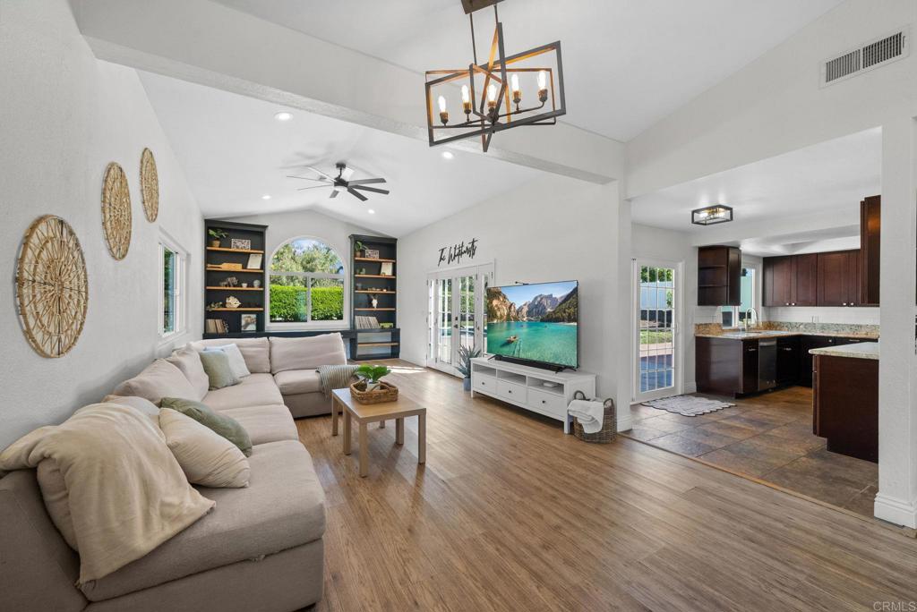41910 Humber Drive Temecula, CA 92591 - Photo 19 of 40 a living room with furniture a fireplace and a flat screen tv