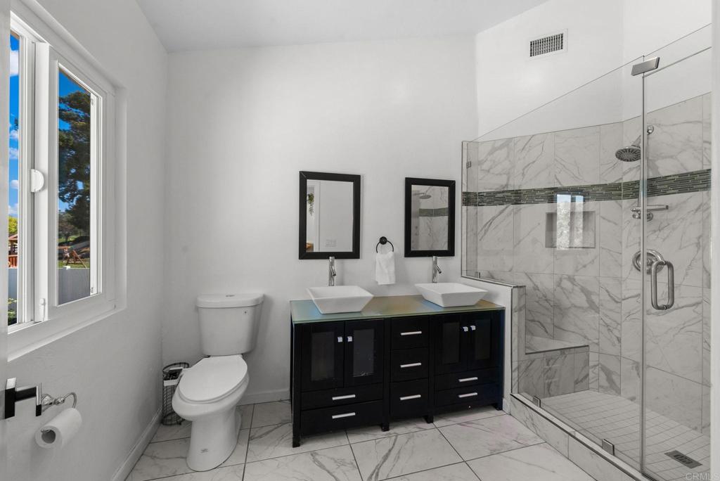 41910 Humber Drive Temecula, CA 92591 - Photo 24 of 40 a bathroom with a double vanity sink mirror and toilet