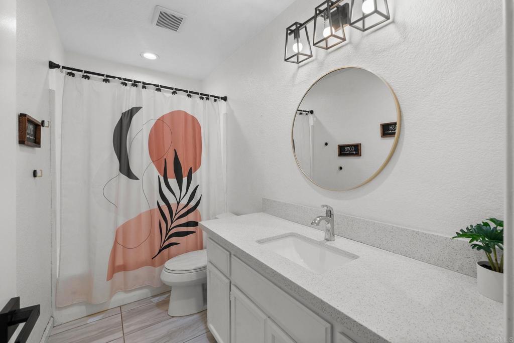 41910 Humber Drive Temecula, CA 92591 - Photo 28 of 40 a bathroom with a toilet a sink and a mirror