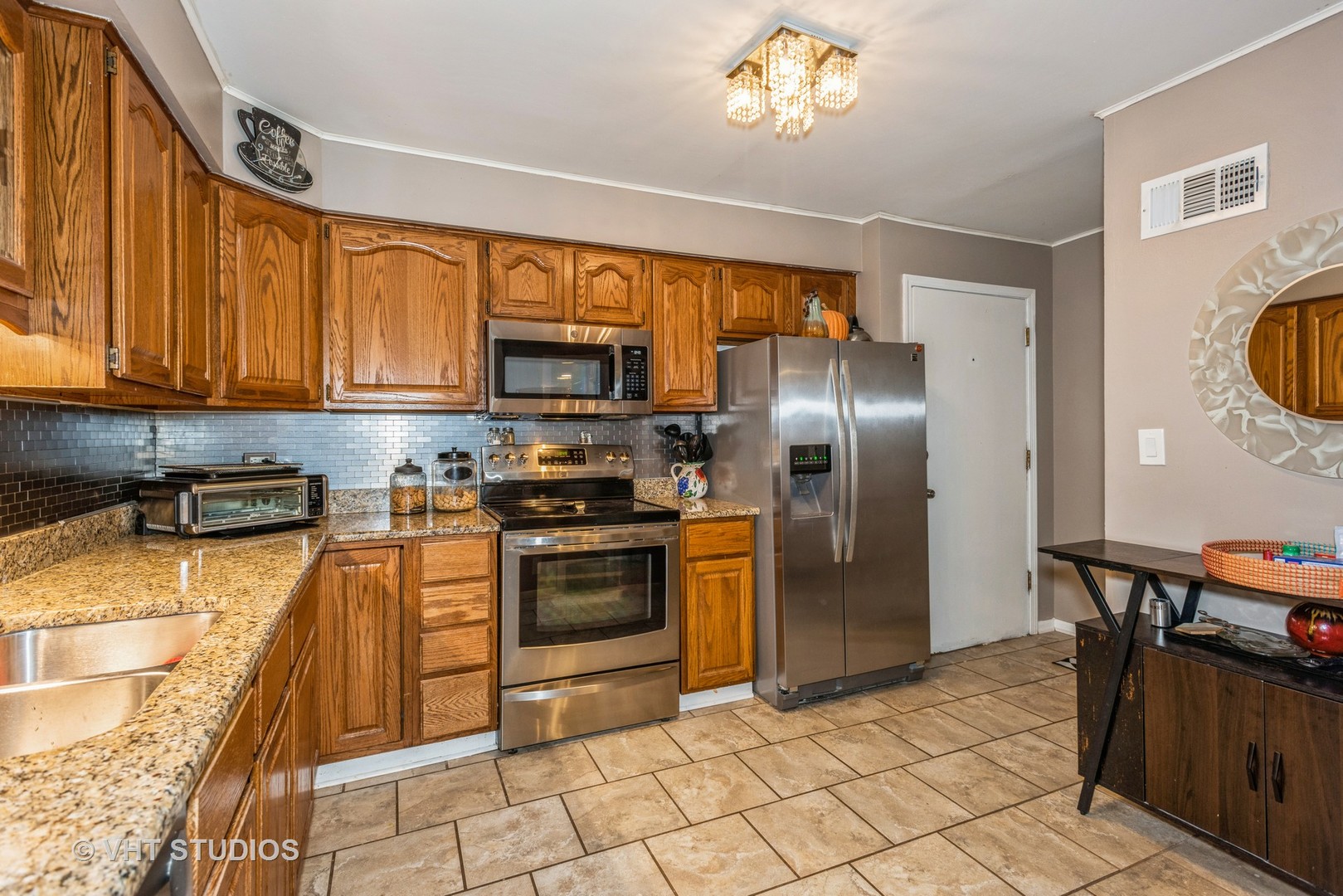 9622 West Higgins Road, Unit 2DS Rosemont, IL 60018 - Photo 8 of 14 a kitchen with stainless steel appliances granite countertop a refrigerator a stove top oven and a sink with granite countertops