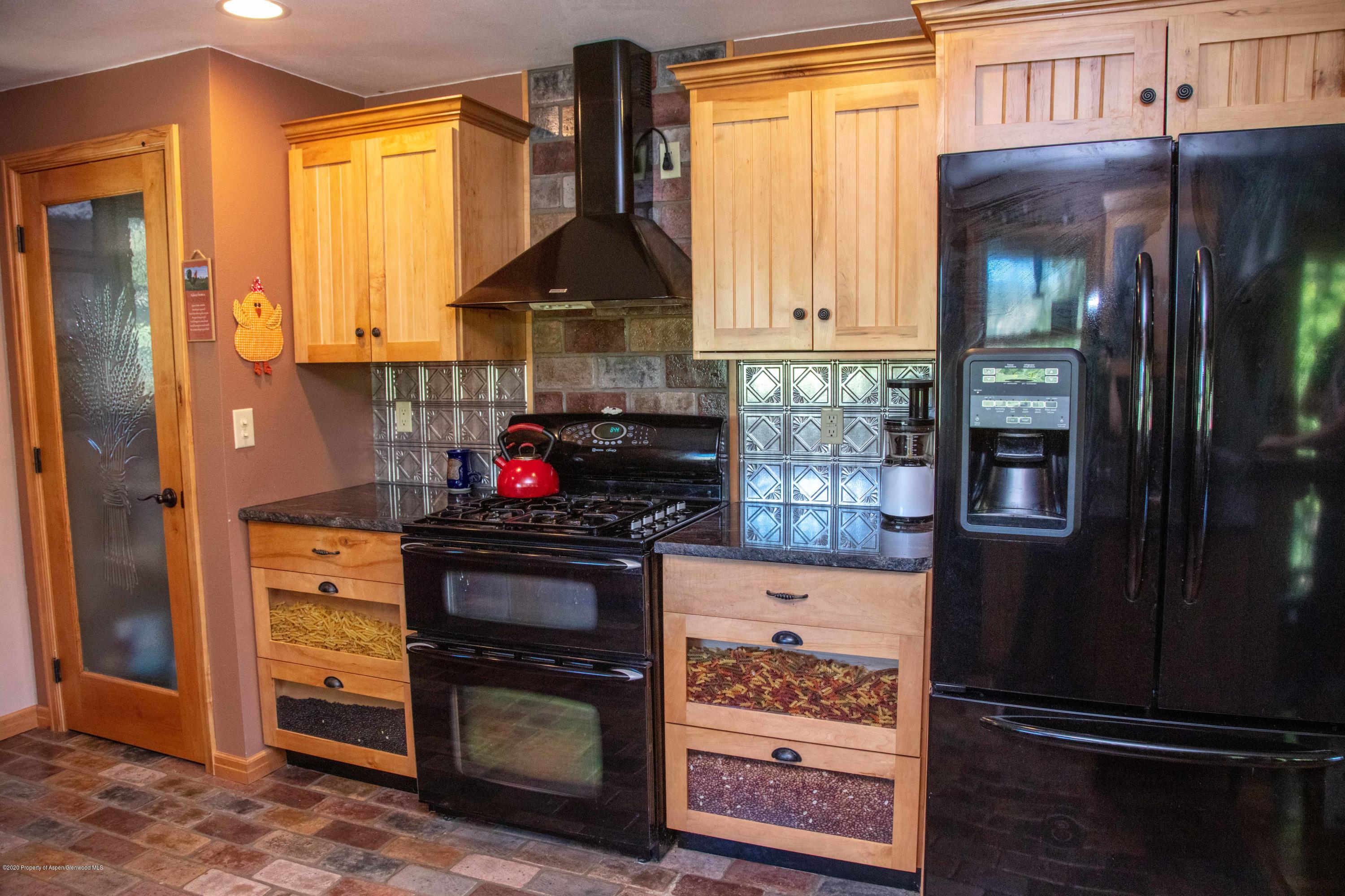 474 Highway 317 Hamilton, CO 81638 - Photo 5 of 31 a kitchen with stainless steel appliances granite countertop a refrigerator and a stove