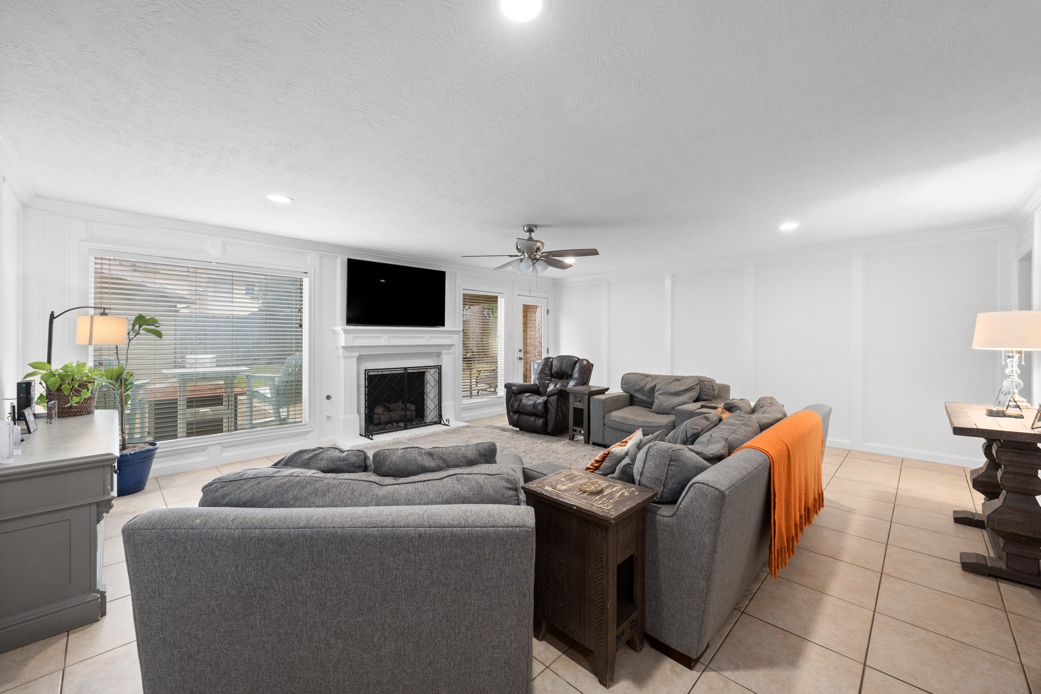 9123 Herts Road Spring, TX 77379 - Photo 13 of 40 At the bak of the home you are met by this massive main living space complete with gas fireplace.