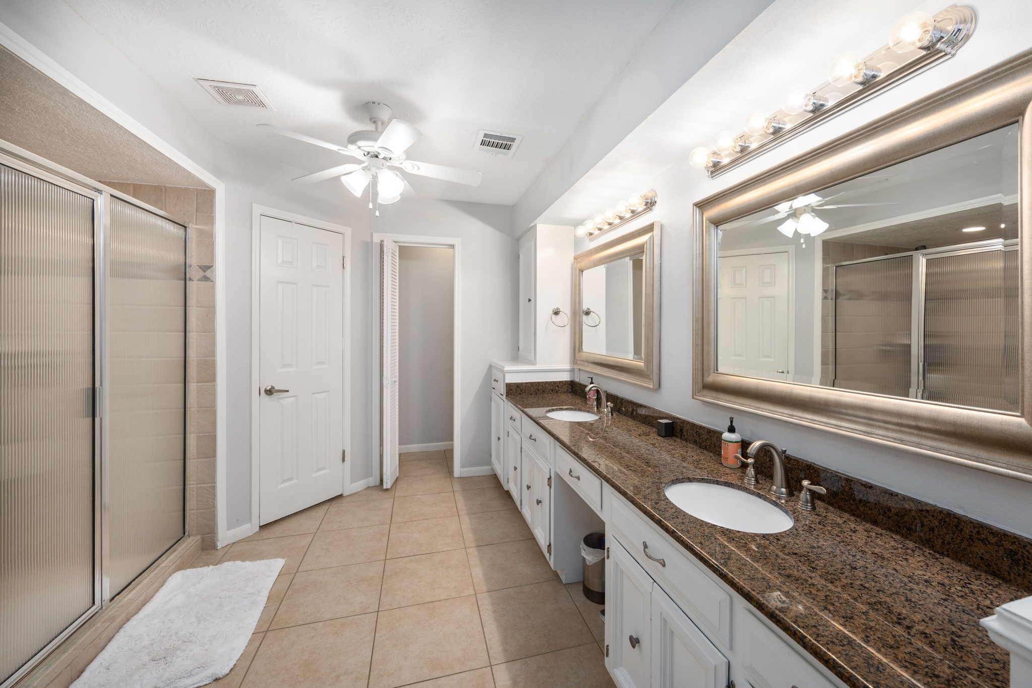 9123 Herts Road Spring, TX 77379 - Photo 26 of 40 The master bath offers separate sink & vanity areas and a massive walk in shower.