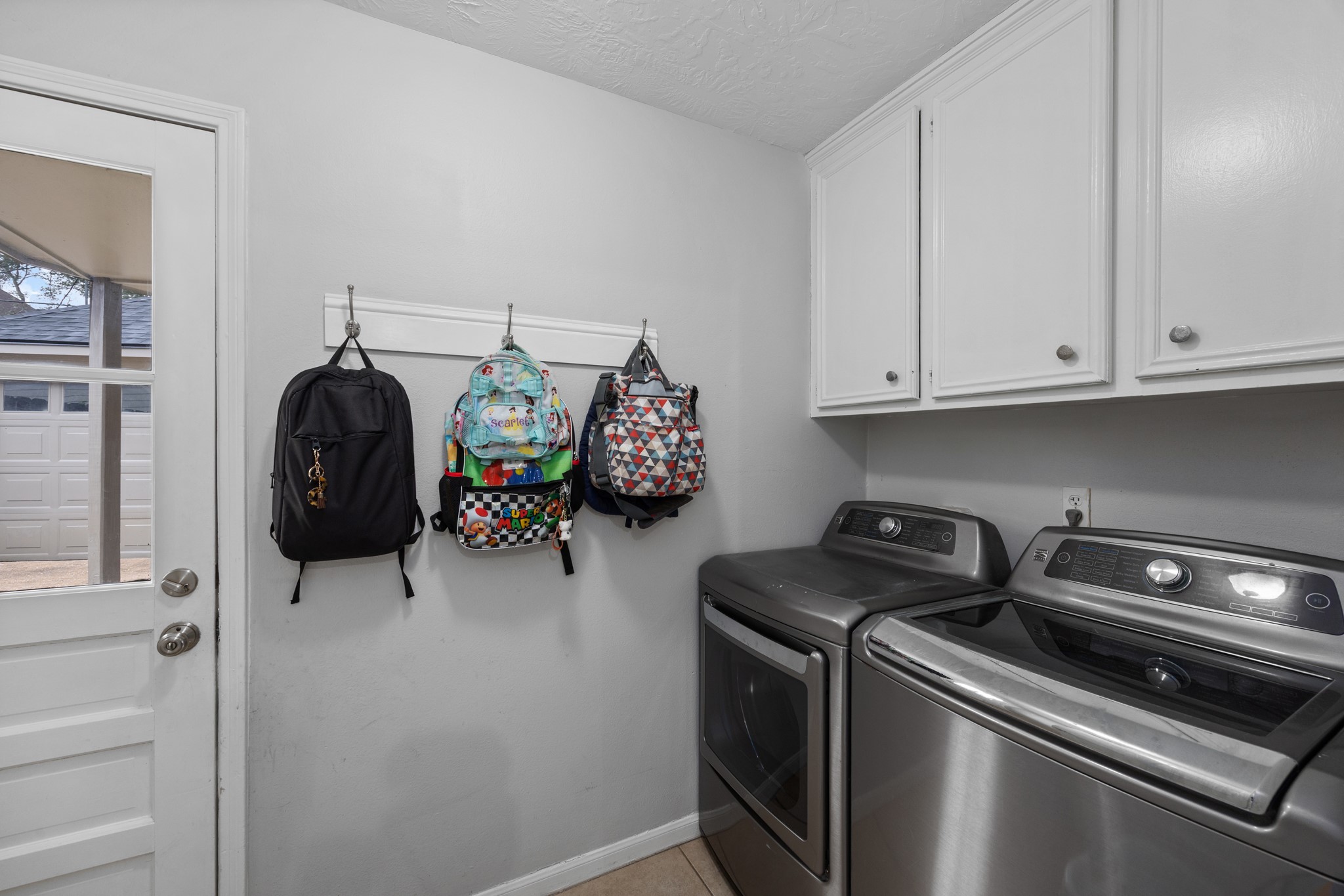 9123 Herts Road Spring, TX 77379 - Photo 33 of 40 The utility room offers access to the covered walkway leading to the detached garage.