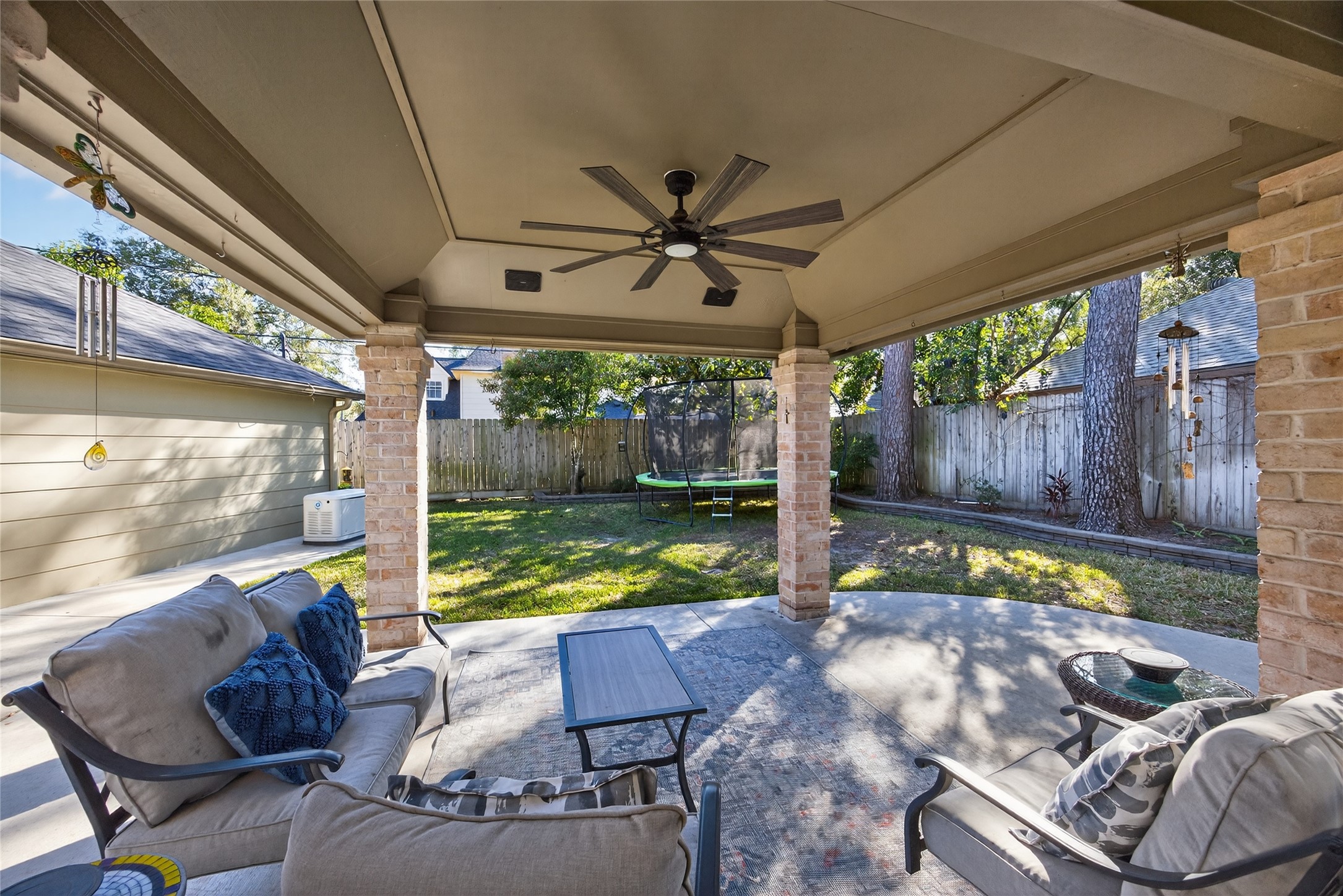 9123 Herts Road Spring, TX 77379 - Photo 36 of 40 The new covered patio features built in speakers and a large fan.