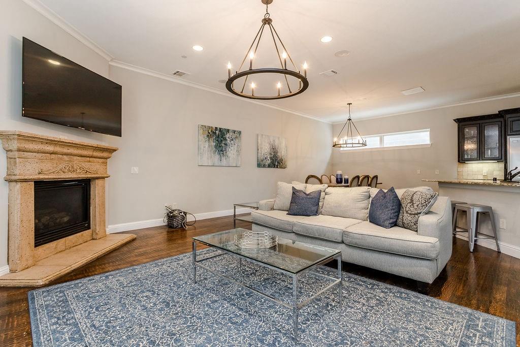 3817 Bowser Avenue, Unit A Dallas, TX 75219 - Photo 11 of 36 a living room with furniture a flat screen tv and kitchen view