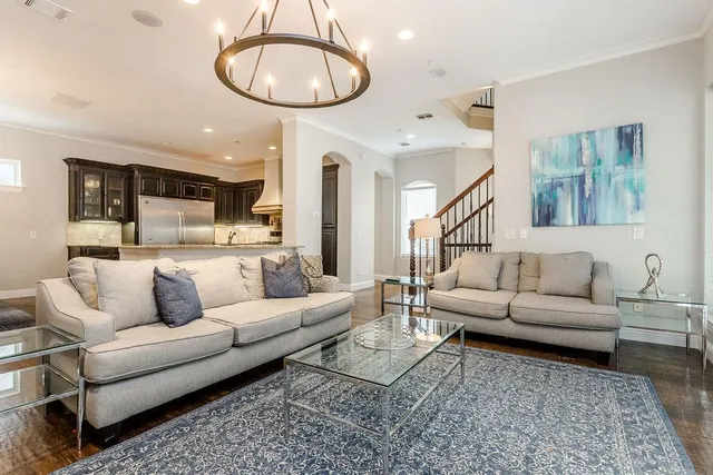 a living room with furniture a couch and kitchen view