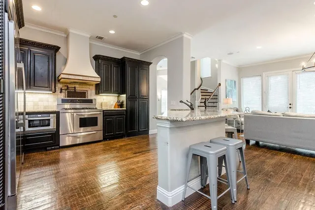 a kitchen with stainless steel appliances a stove a sink dishwasher and a refrigerator
