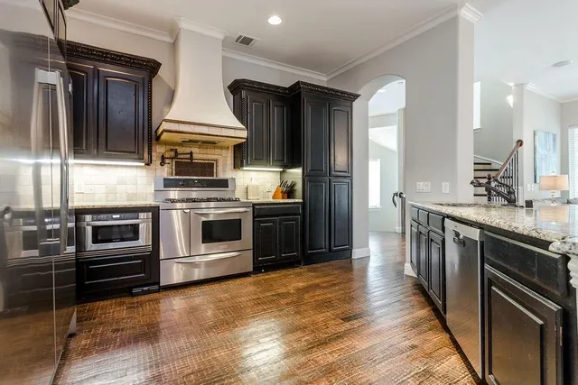 a kitchen with stainless steel appliances and cabinets