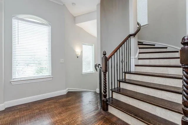 a view of entryway with wooden floor and front door
