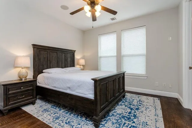 a bed sitting in a bedroom next to a window