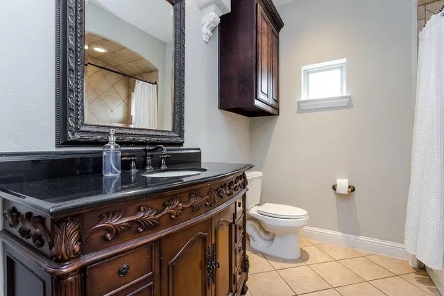a bathroom with a stove a sink and a mirror