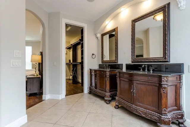 a view of a hallway with workspace and bathroom
