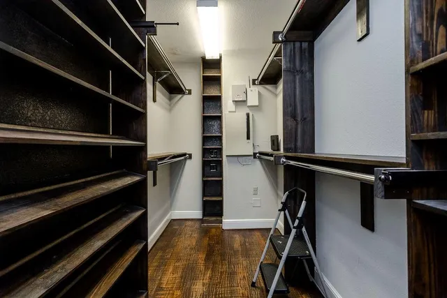 a view of walk in closet with clothes and shoes