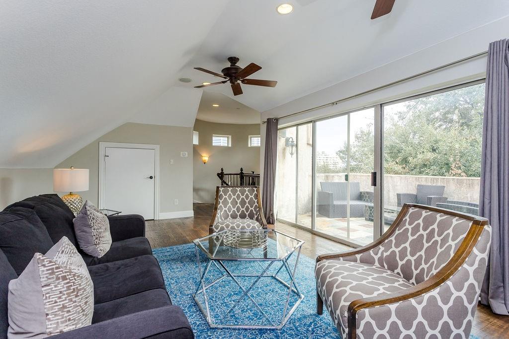 3817 Bowser Avenue, Unit A Dallas, TX 75219 - Photo 34 of 36 a living room with furniture and a floor to ceiling window