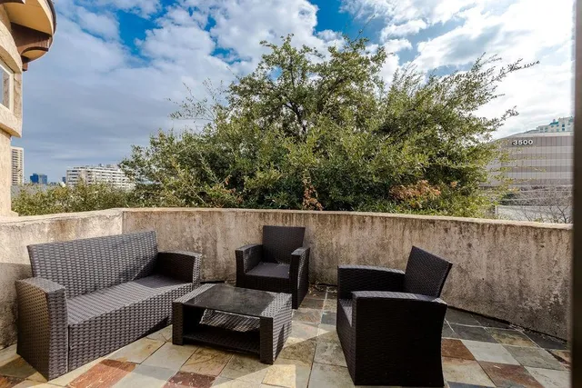 a view of sitting area with furniture and wooden fence