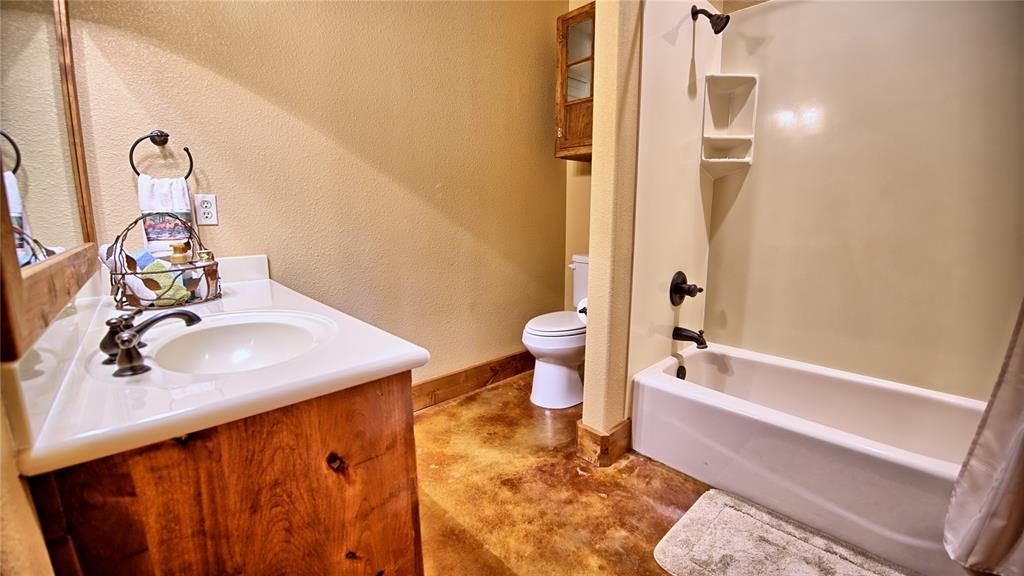 4509 Lazy E Road St. Jo, TX 76265 - Photo 15 of 39 a bathroom with a sink toilet and shower