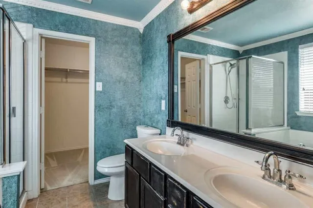 a bathroom with a double vanity sink toilet and a mirror