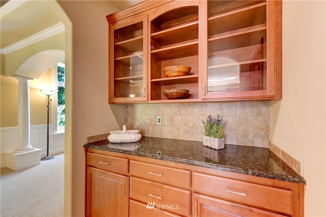 3704 Maple Road Lynnwood, WA 98037 - Photo 11 of 30 a kitchen with stainless steel appliances granite countertop a sink a stove and a wooden cabinets