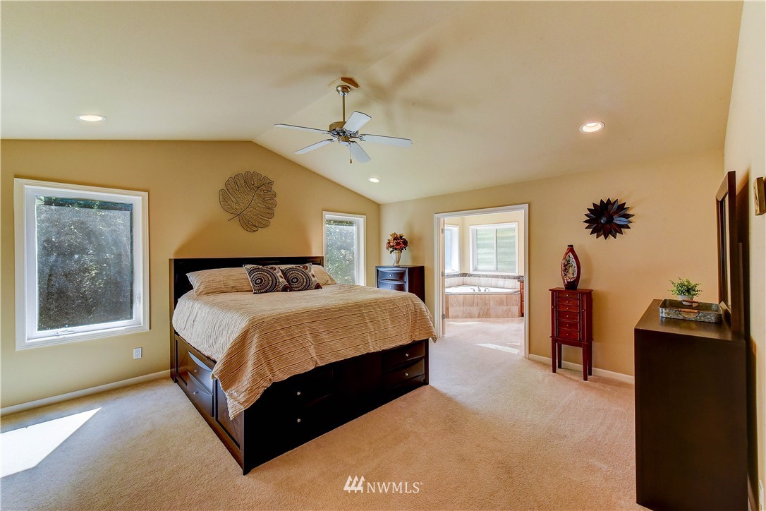 3704 Maple Road Lynnwood, WA 98037 - Photo 14 of 30 a bedroom with a bed and a chandelier