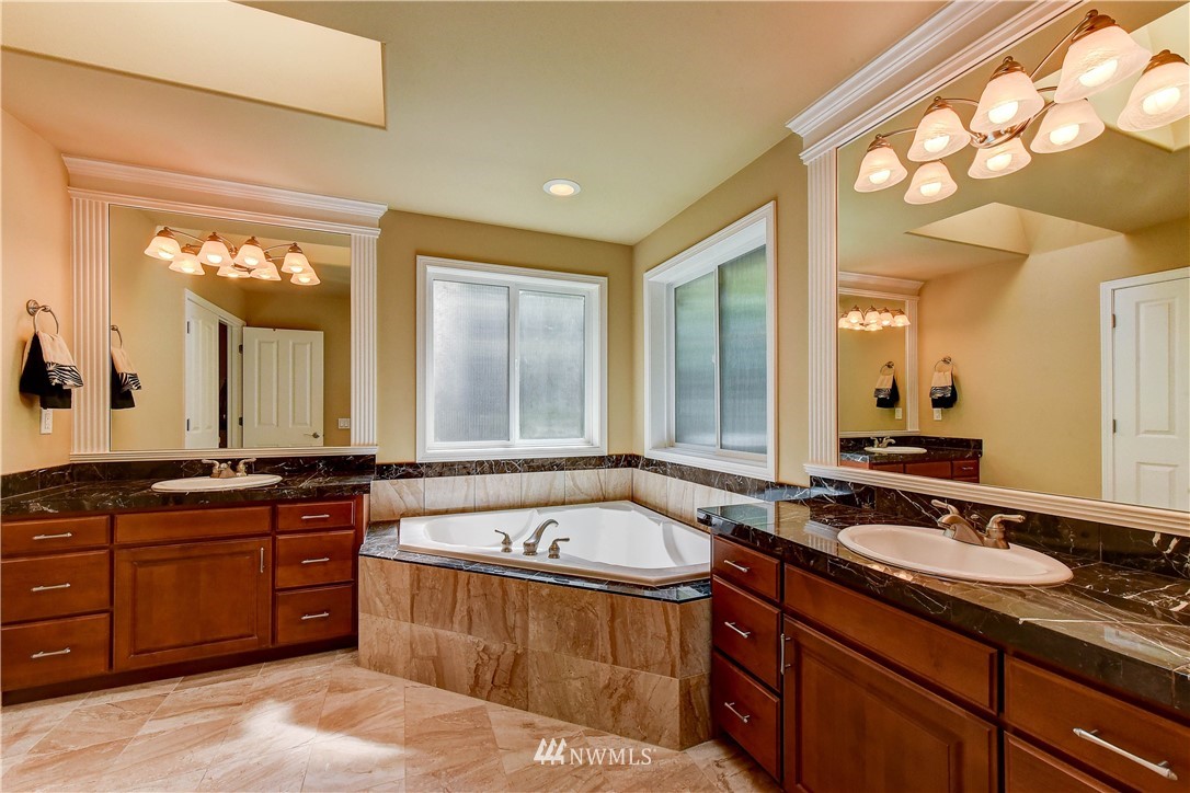 3704 Maple Road Lynnwood, WA 98037 - Photo 18 of 30 a spacious bathroom with a tub sink and mirror