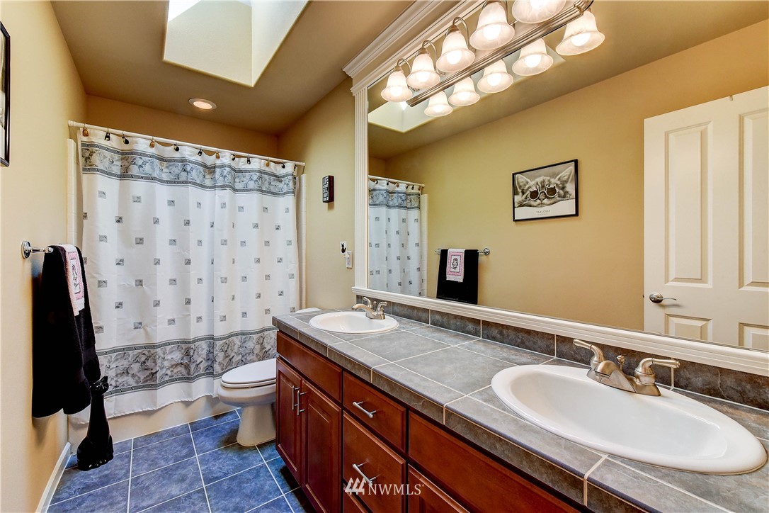 3704 Maple Road Lynnwood, WA 98037 - Photo 22 of 30 a bathroom with a granite countertop sink toilet and shower