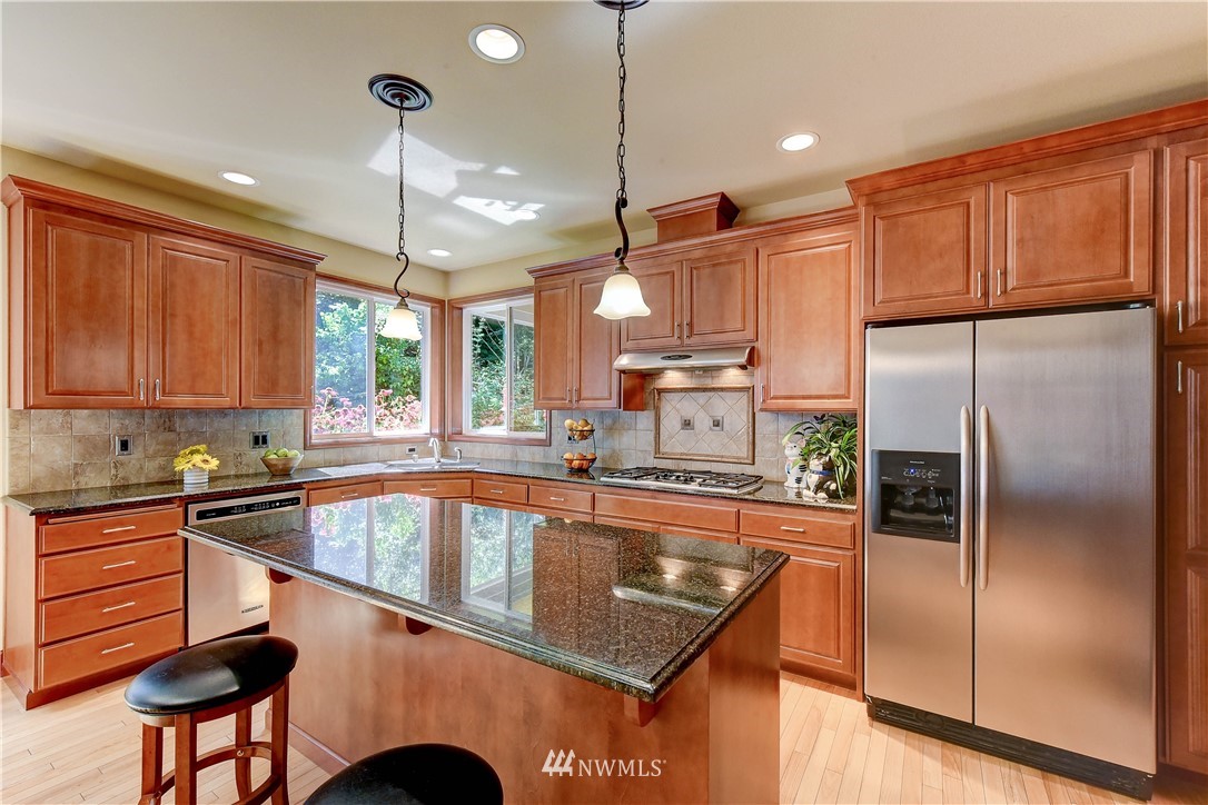 3704 Maple Road Lynnwood, WA 98037 - Photo 7 of 30 a kitchen with stainless steel appliances granite countertop a refrigerator a sink and a stove