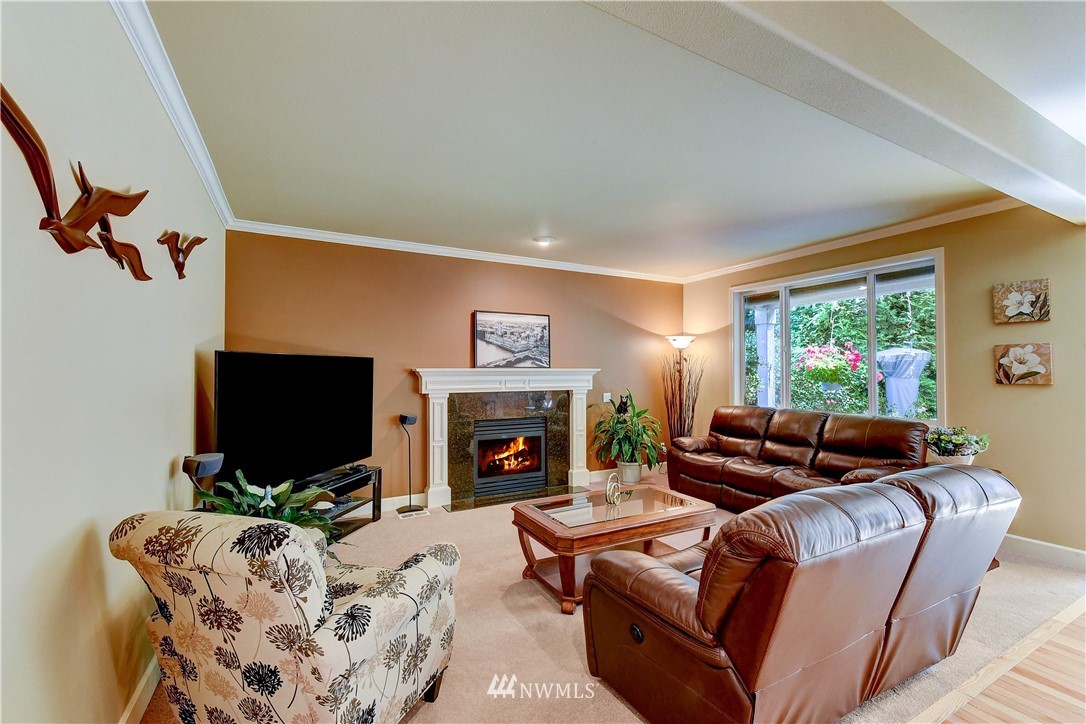 3704 Maple Road Lynnwood, WA 98037 - Photo 10 of 30 a living room with furniture flat screen tv and a fireplace