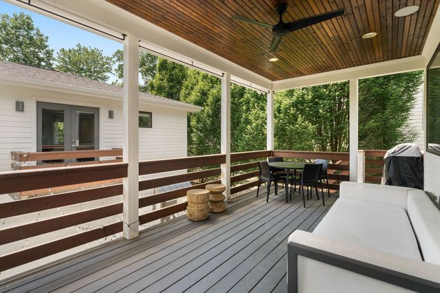 a view of a patio with table and chairs floor to ceiling window with wooden floor