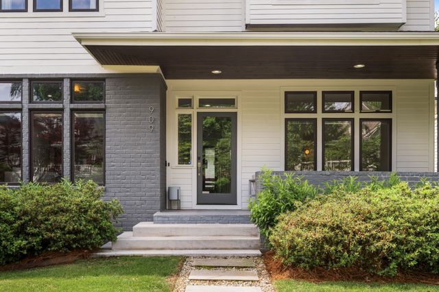 a front view of a house with plants