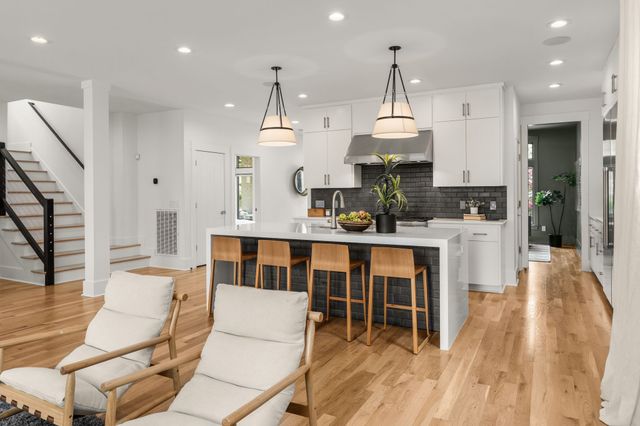 a dining room with furniture a chandelier and wooden floor