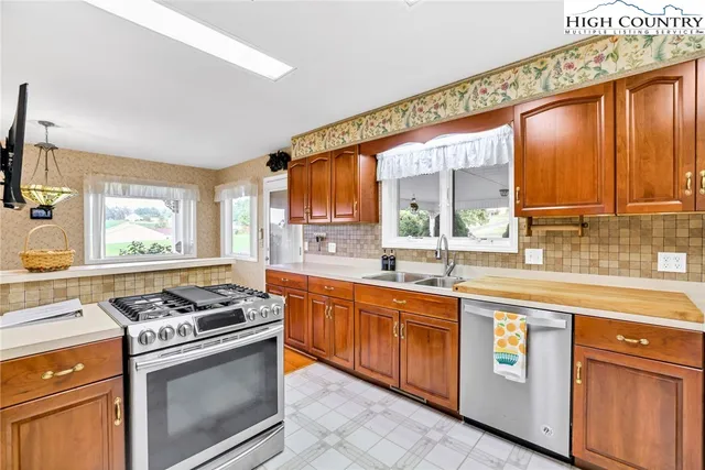 a kitchen with stainless steel appliances granite countertop a stove and a sink
