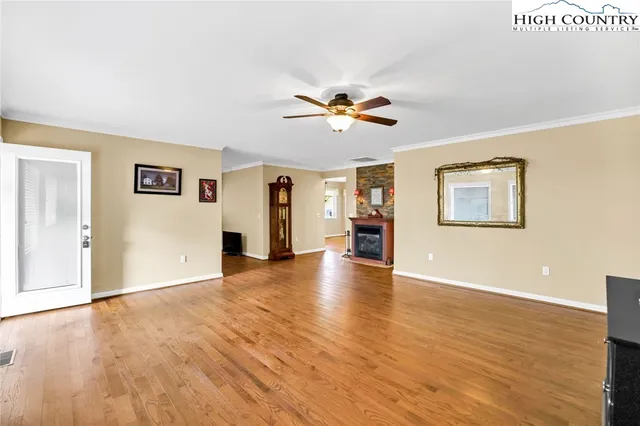 a view of a livingroom with a hardwood floor and a ceiling fan