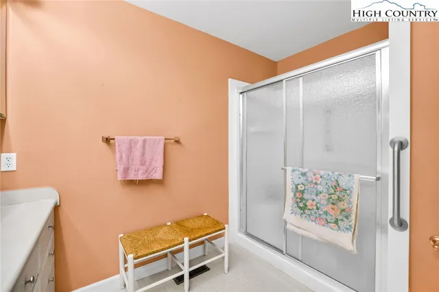 a bathroom with a window and a shower