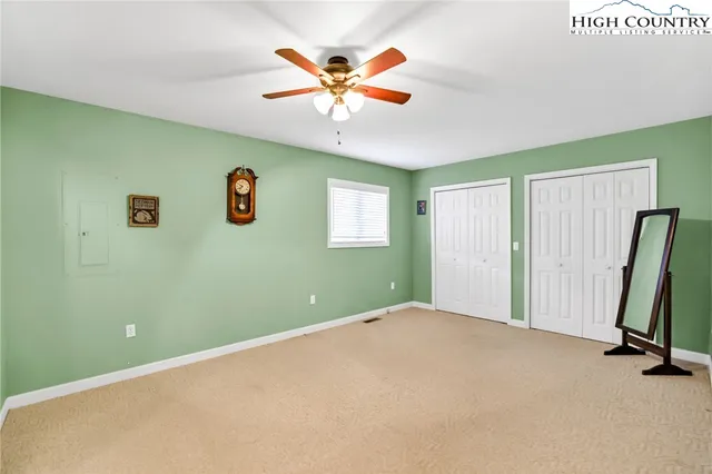 a view of a livingroom with a ceiling fan and a window