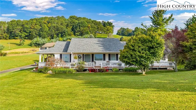a view of a house with a yard porch and sitting area
