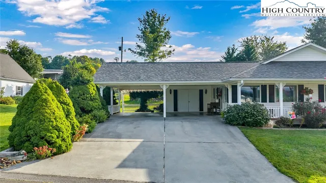 a view of a house with swimming pool and a yard