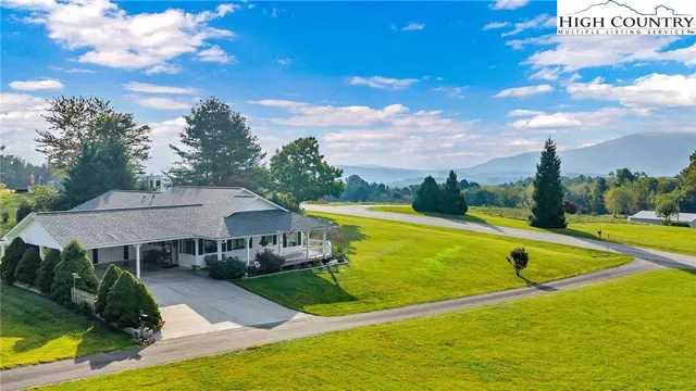 a view of a house with pool and a view of a city