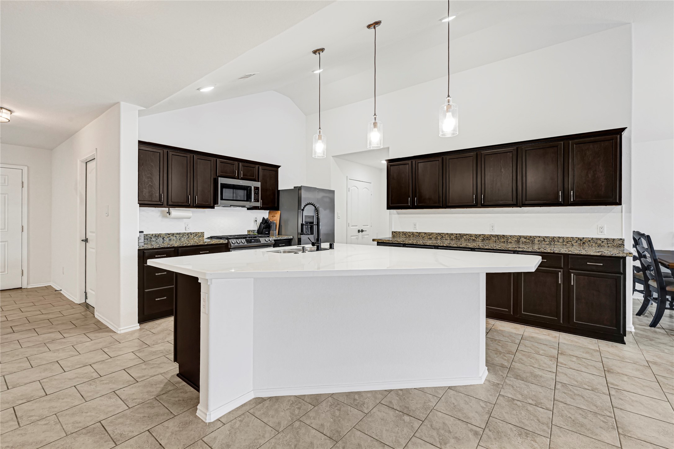 23343 Dukes Run Drive Spring, TX 77373 - Photo 5 of 21 a kitchen with stainless steel appliances a stove a sink a microwave a refrigerator and cabinets