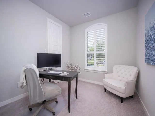 a workspace with furniture and a window