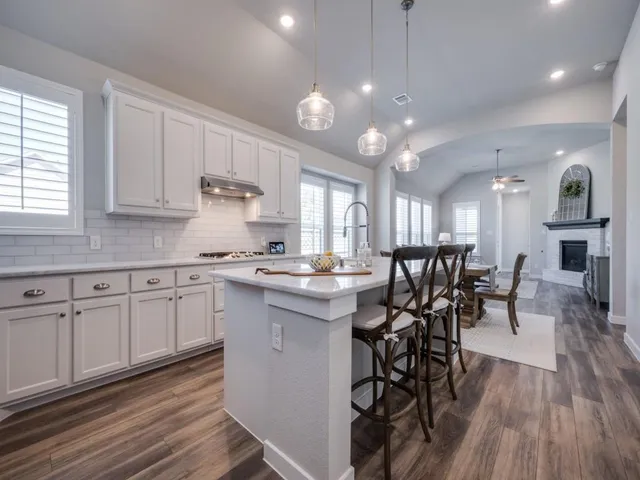 a kitchen with cabinets a sink and appliances in it
