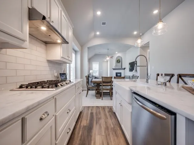 a kitchen with sink stove and cabinets