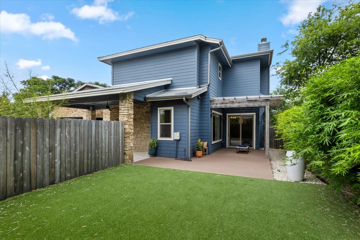 913 Stobaugh Street, Unit B Austin, TX 78757 - Photo 7 of 40 A private backyard oasis awaits, featuring a spacious deck and lush artificial turf.