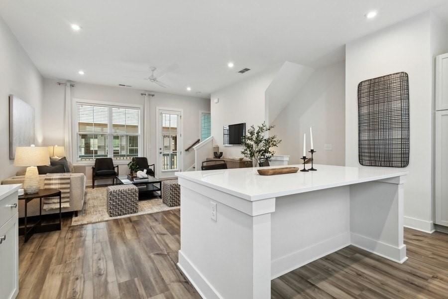 776 Metropolitan Parkway Southwest, Unit 3A Atlanta, GA 30310 - Photo 6 of 22 a view of kitchen center island sink stainless steel appliances wooden floor and living room view