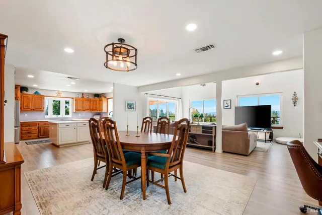 a kitchen with stainless steel appliances granite countertop a sink a stove and a microwave