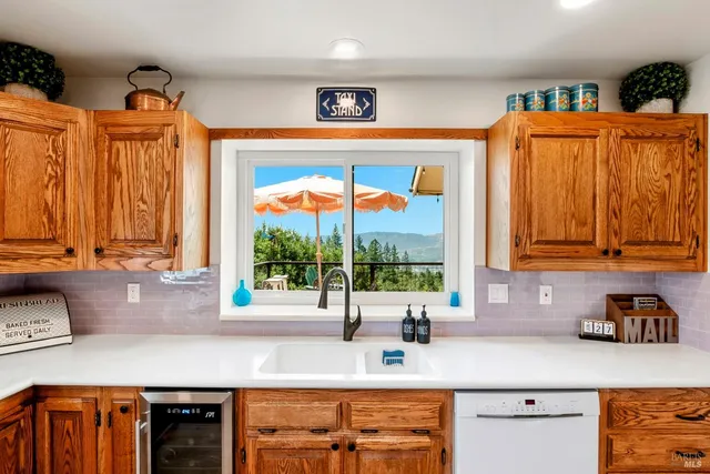 a large white kitchen with stainless steel appliances granite countertop a stove and a refrigerator