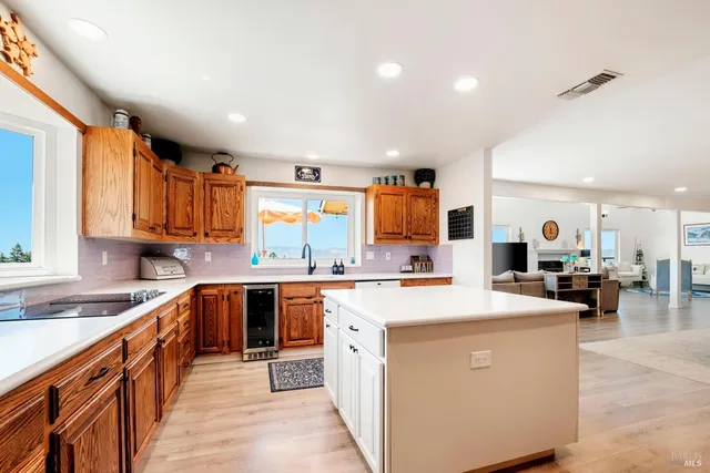 a spacious bedroom with a large bed and a chandelier