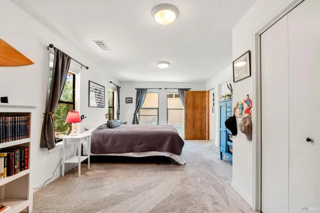 a bedroom with a bed and a closet